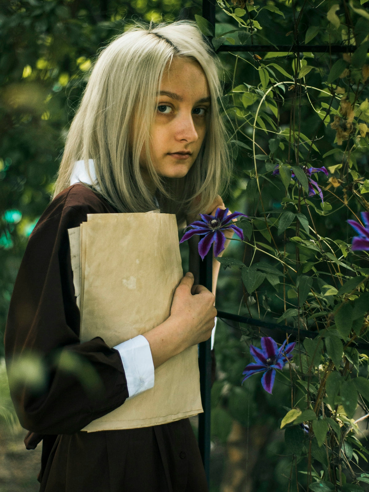 a woman with blonde hair holding a brown paper bag