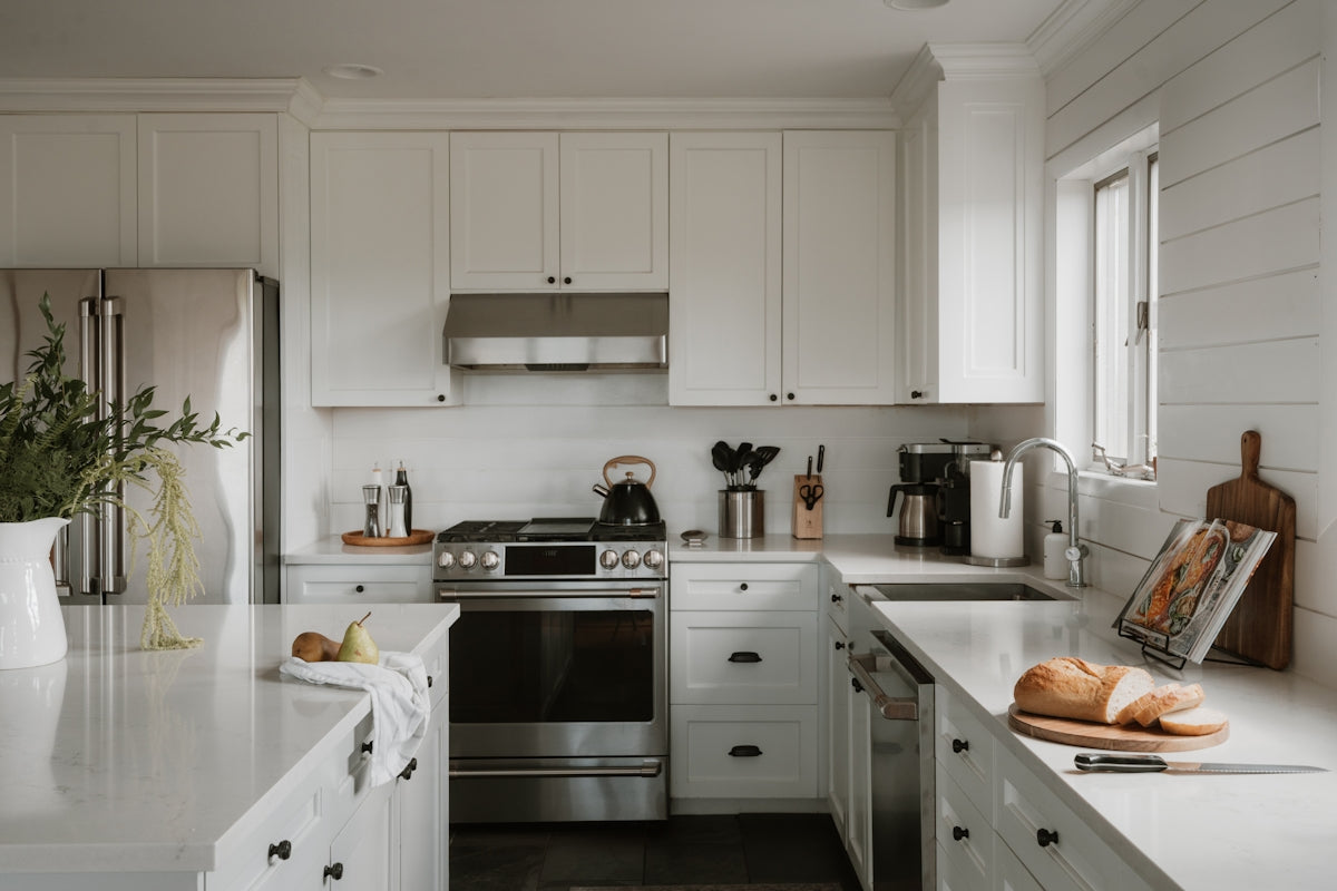 Bright, modern kitchen with white cabinets and stainless steel appliances